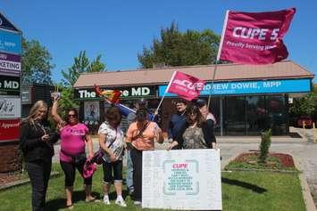 Members of CUPE Local 8916 demonstrate outside MPP Andrew Dowie's constituency office in Windsor, May 8, 2024. Photo by Mark Brown/WindsorNewsToday.ca.