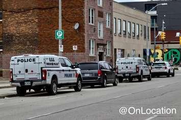 Windsor police vehicles parked near possible standoff on Pelissier Street near Wyandotte Street West, February 16, 2023. Photo courtesy On_Location/Twitter.