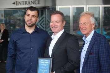 Chaouki Hamka, left, of MADD Windsor and Essex County, Kevin Laforet of Caesars Windsor, and Andrew Murie of MADD Canada present a plaque to Caesars Windsor to mark their partnership in the Campaign 911 program, June 13, 2019. Photo by Mark Brown/Blackburn News.