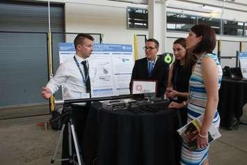 Joseph Guignard, left, Scott Dos Santos and Hannah O'Neil explain their capstone project at the University of Windsor Ed Lumley Centre for Engineering Innovation, July 26, 2019. Photo by Mark Brown/Blackburn News.