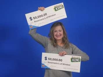 Rosemarie Sablone of Windsor shows off her $50,000 cheque for playing Daily Keno, at the OLG Prize Centre in Toronto, November 10, 2022. Photo provided by OLG.