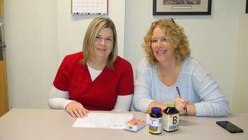 Pharmacy Technician Connie Newman (left) and Director of Pharmacy Nancy Kay (right) go over a patient's medication list.