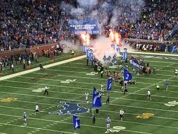 Members of the Detroit Lions run out of the tunnel at Ford Field. (Photo by Mike James)