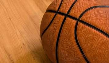 Basketball on a wooden floor close up. © Can Stock Photo / johnnychaos
