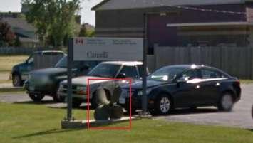 Antique propeller seen underneath the sign of a government building in Leamington. (Photo provided by Essex County OPP)