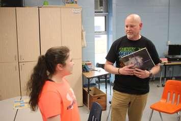 Fred Fox, brother of Terry Fox, presents Jocelyn Adams with a thank-you gift at St. Pius X School in Tecumseh, May 6, 2019. Fred Fox, brother of Terry Fox, meets with Grade 7 student Jocelyn Adams at St. Pius X School in Tecumseh, May 6, 2019. Photo by Mark Brown/WindsorNewsToday.ca.