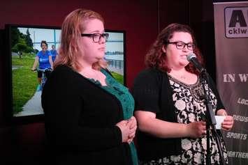 Courtney Quinn-Lafond (left) and Jessica Tetreault (right) talk about mental health issues at the Ride Dont Hide launch in downtown Windsor, May 7, 2015. (Photo by Mike Vlasveld)