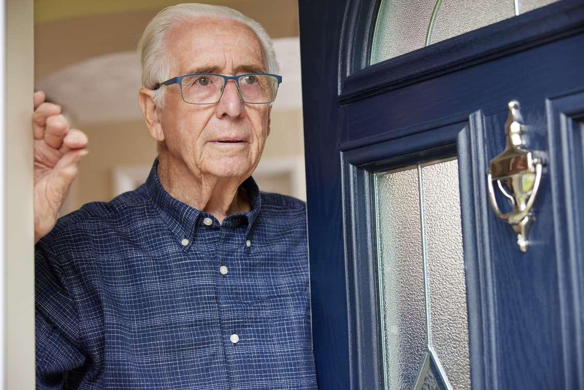 senior answering door (Photo courtesy of Daisy-Daisy / Royalty-free / iStock / Getty Images Plus)
