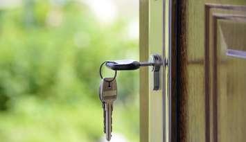 Keys in a house door for rent or home sale stories.
