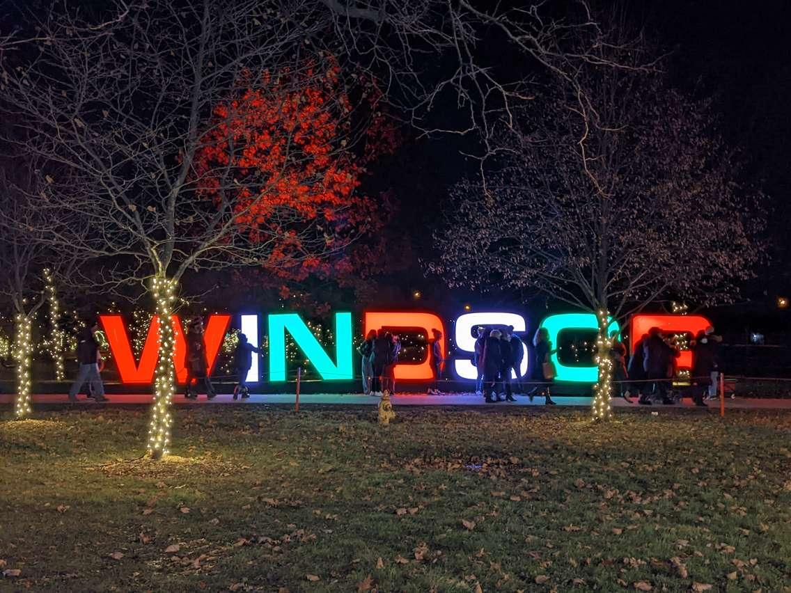 Visitors to Bright Lights Windsor congregate near a light display at Jackson Park, December 4, 2021. Photo by Mark Brown/WindsorNewsToday.ca.