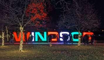 Visitors to Bright Lights Windsor congregate near a light display at Jackson Park, December 4, 2021. Photo by Mark Brown/WindsorNewsToday.ca.