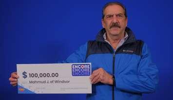 Mahmud Jabbar of Windsor shows off his $100,000 cheque at the OLG Prize Centre in Toronto, October 25, 2024