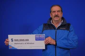 Mahmud Jabbar of Windsor shows off his $100,000 cheque at the OLG Prize Centre in Toronto, October 25, 2024