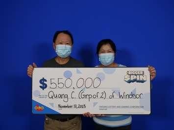 Minh Quang Chung and Tran Truong of Windsor show off their $550,000 prize cheque at the OLG Prize Centre in Toronto, November 17, 2023. Photo provided by Ontario Lottery and Gaming.