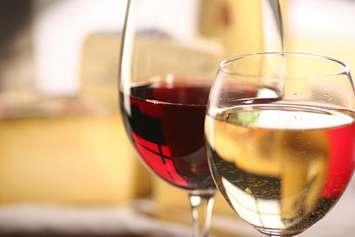 Glasses of red and white wines. File photo courtesy of © Can Stock Photo / fredredhat.