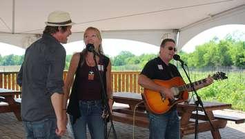 John and Michele Law, producers of the Kingsville Folk Music Festival and singer Glen MacNeil at the media launch for the event, June 14, 2017. (Photo by Maureen Revait) 