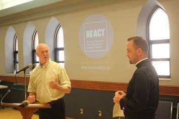 Bob Cameron, executive director of the Downtown Windsor Community Collaborative; and the Rev. Robert Clifford, rector of All Saints Anglican Church, unveil the new ReAct addiction recovery program on July 11, 2019. Photo by Mark Brown, Blackburn News.