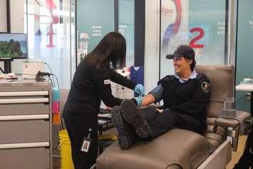 A Windsor Police Auxiliary officer donates plasma at the Plasma Donation Centre in Windsor, February 28, 2024. (Photo by Maureen Revait) 