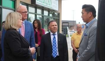 From left, Carolyn Warkentin, South Essex Community Council Executive Director; Rob Flack, Ontario Minister of Agriculture, Food, and Agribusiness; Essex MPP Anthony Leardi, and Ontario Greenhouse Vegetable Growers Executive Director Richard Lee, in Kingsville, September 27, 2024. Photo by Mark Brown/WindsorNewsToday.ca.