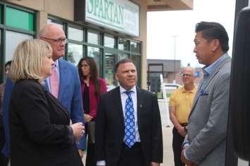 From left, Carolyn Warkentin, South Essex Community Council Executive Director; Rob Flack, Ontario Minister of Agriculture, Food, and Agribusiness; Essex MPP Anthony Leardi, and Ontario Greenhouse Vegetable Growers Executive Director Richard Lee, in Kingsville, September 27, 2024. Photo by Mark Brown/WindsorNewsToday.ca.