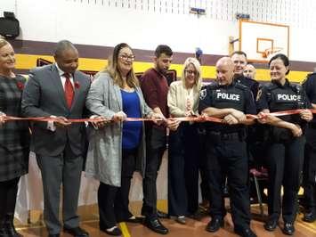 Chaouki Hamka, centre, of MADD Windsor and Essex County, prepares to cut a red ribbon with law enforcement and other representatives at Catholic Central High School in Windsor, November 1, 2018. Photo by Mark Brown/Blackburn News.