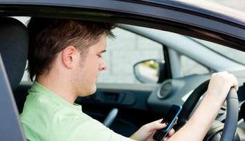 Distracted driving file photo courtesy of © Can Stock Photo Inc. / 4774344sean