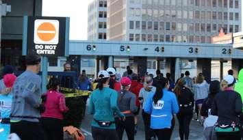 Runners enter the Windsor-Detroit Tunnel Plaza during the Detroit Free Press Marathon, 2014.  (Photo by Adelle Loiselle.)