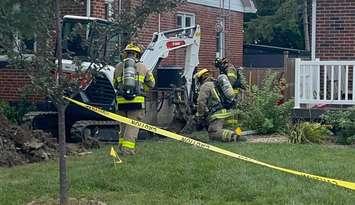 Firefighters attend the scene at 67 Queen Street South in Tilbury after an oily substance was found during some digging. (Photo courtesy of Chatham-Kent Fire and Emergency Services)