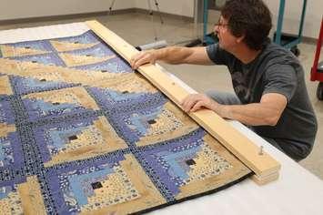Lambton Heritage Museum prepares quilts for hanging in the 2025 North Lambton Quilters’ Guild Quilt Show. Submitted photo.  -------------------------------------