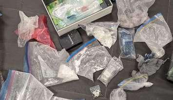 An assortment of suspected illicit drugs, cash, and other items are displayed on October 7, 2024. Photo courtesy LaSalle police.