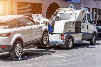 A vehicle hooked up to a tow truck. File photo courtesy of © Can Stock Photo / aapsky