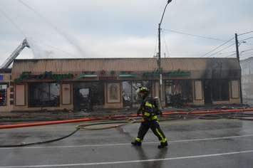 A firefighter walks passed the fire at El Mayor restaurant in Windsor, January 3, 2019. (Photo by Adelle Loiselle)