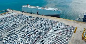 (Vehicles waiting on a dock courtesy of Unifor)