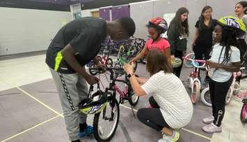 Students at W.J. Langlois receive new bikes from Unifor Local 444, June 25, 2024. (Photo by Maureen Revait) 