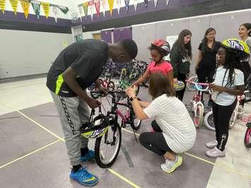 Students at W.J. Langlois receive new bikes from Unifor Local 444, June 25, 2024. (Photo by Maureen Revait) 