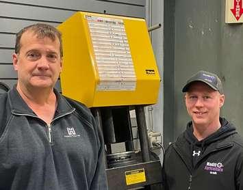 Jeff Cowan(r), Transportation teacher and head of the Technology Department at FEMSS, receiving the donation of a
hydraulic hose crimper from Brian Young, Huron Tractor Parts Manager. Photo courtesy of Avon Maitland District School Board.