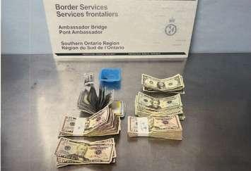 U.S. cash and a small quantity of morphine seized on January 13, 2024 at the Ambassador Bridge is displayed. Photo courtesy CBSA SOR Region/X.