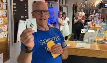 Branch 62 First Vice President Les Jones unveils the card selected at Catch the Ace draw, July 18, 2024. 