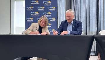 Municipality of Lakeshore Mayor Tracey Bailey and University of Windsor President Robert Gordon sign MOU, May 20, 2025. (Photo by Maureen Revait) 