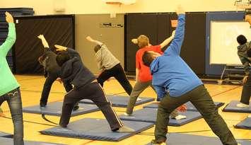 Grade 7 students at Tecumseh Vista Academy practice yoga during gym class. (BlackburnNews.com file photo)
