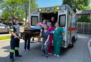 Hospice resident, Sandra, poses for a photo with Hospice staff and EMS volunteers before her outing to C.M. Wilson Conservation Area as part of the Lasting Memories Program (Image courtesy of the Chatham-Kent Hospice Foundation)