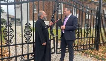 Father Moses from the St. Mary and St. Moses Coptic Orthodox Church in Windsor speaks to MP Irek Kusmierczyk, November 15, 2024. (photo by Maureen Revait)