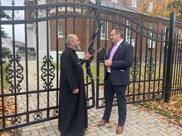 Father Moses from the St. Mary and St. Moses Coptic Orthodox Church in Windsor speaks to MP Irek Kusmierczyk, November 15, 2024. (photo by Maureen Revait)