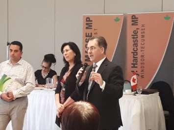 Windsor West MP Brian Masse, with microphone, and Windsor Tecumseh MP Cheryl Hardcastle discuss concerns facing convenience store owners as store owner Terry Yaldo, left, looks on, at the Fogolar Furlan Club in Windsor, November 30, 2018. Photo by Mark Brown/Blackburn News.