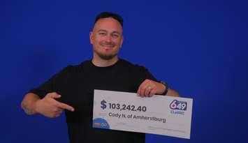 Cody Northgrave of Amherstburg displays his winnings at the OLG Prize Centre in Toronto. Photo courtesy Ontario Lottery and Gaming.