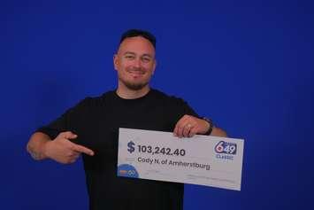 Cody Northgrave of Amherstburg displays his winnings at the OLG Prize Centre in Toronto. Photo courtesy Ontario Lottery and Gaming.