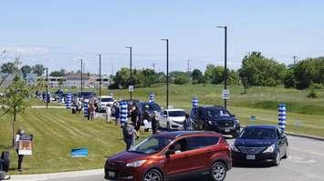 Students from Lambton College taking part in drive-by graduation parade at the Sarnia school. 24 June 2020. (BlackburnNews.com photo by Colin Gowdy)