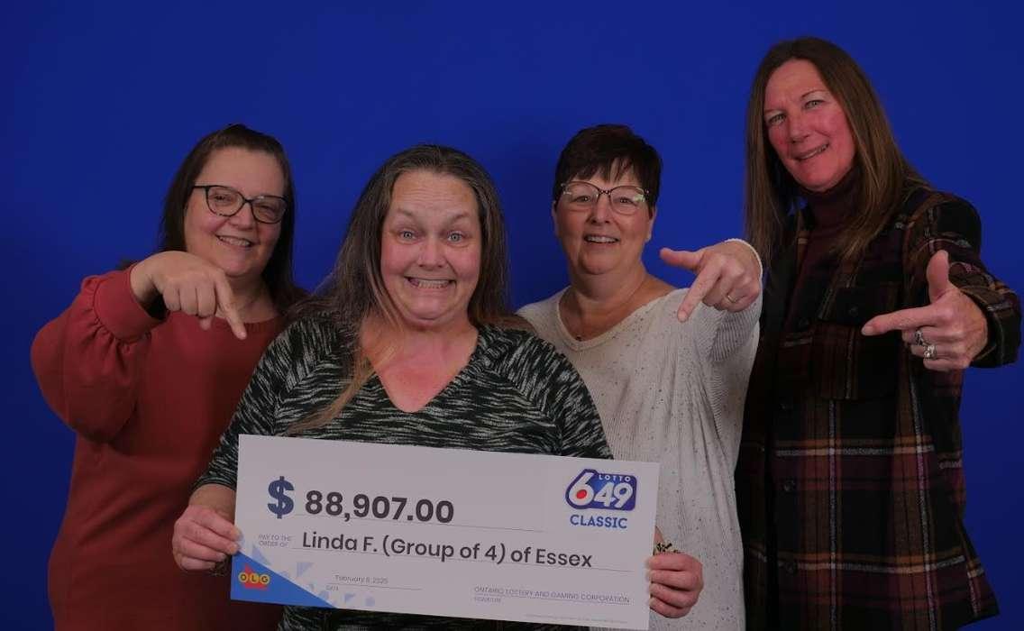 (Photo of four co-workers picking up their lottery winnings courtesy of the Ontario Lottery and Gaming Corporation)