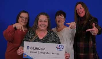 (Photo of four co-workers picking up their lottery winnings courtesy of the Ontario Lottery and Gaming Corporation)