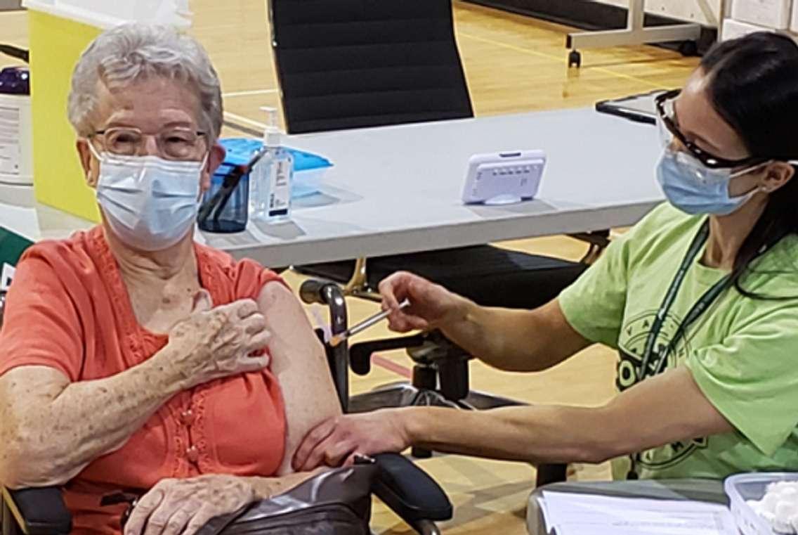 Shirley Banks, 88, is the first person to receive the COVID-19 vaccine at the  North London Optimist Community Centre, March 17, 2021. Photo courtesy of the Middlesex London Health Unit.